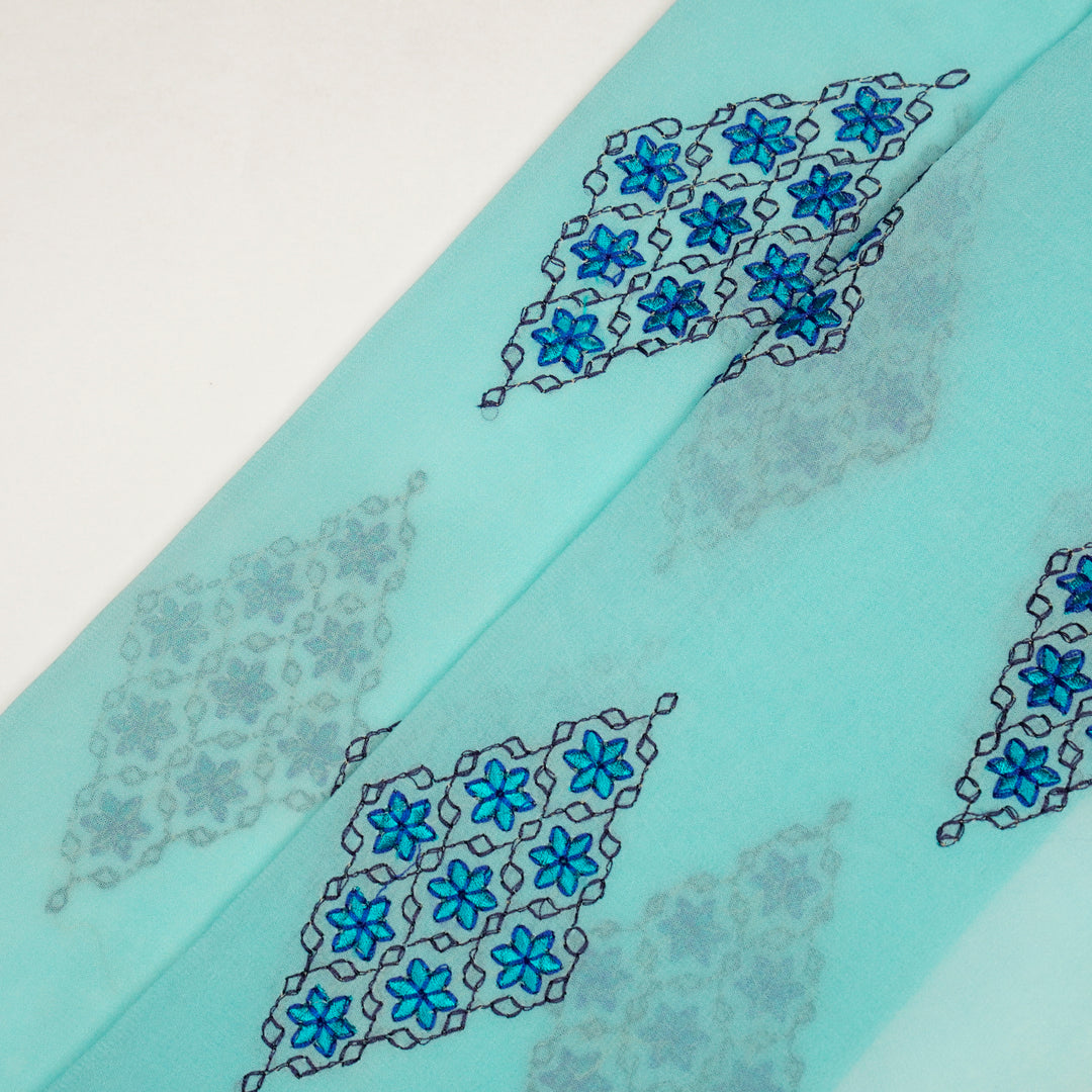 Aseela Buta on Aqua Semi Georgette Embroidered Fabric