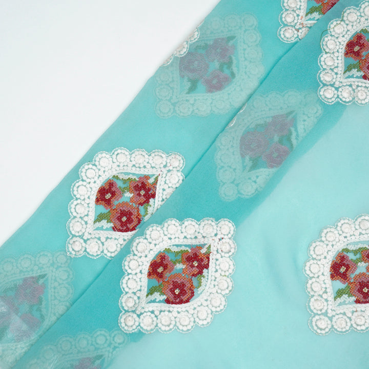 Zinal Buta on Turquoise Semi Georgette Embroidered Fabric