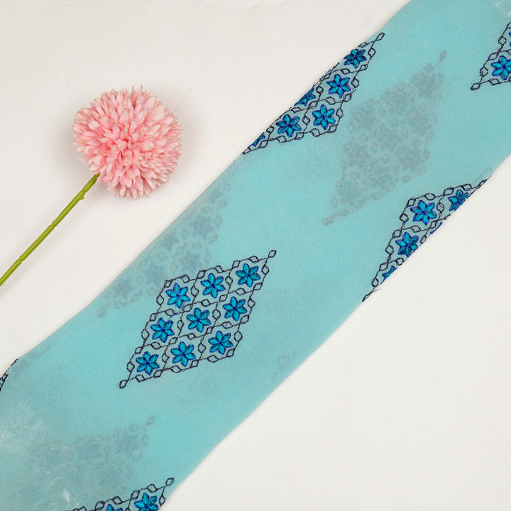 Aseela Buta on Aqua Semi Georgette Embroidered Fabric